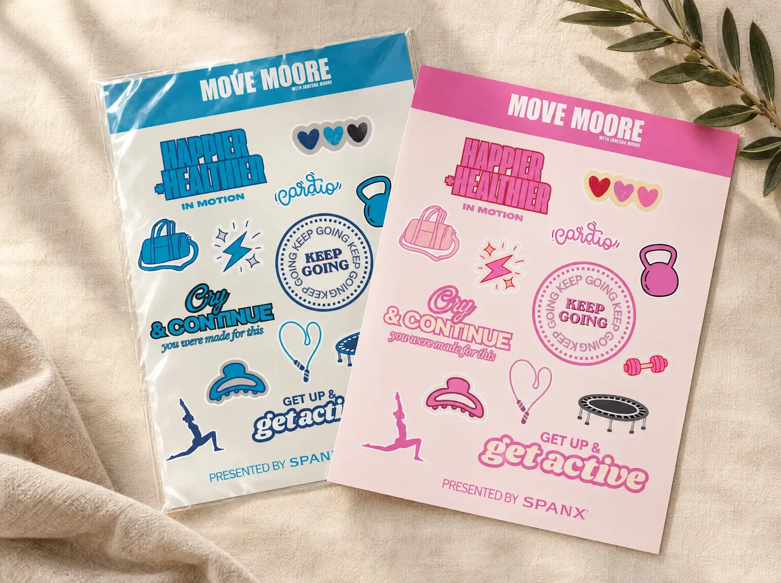 Two Move Moore sticker sheets, one blue and one pink, on cream linen