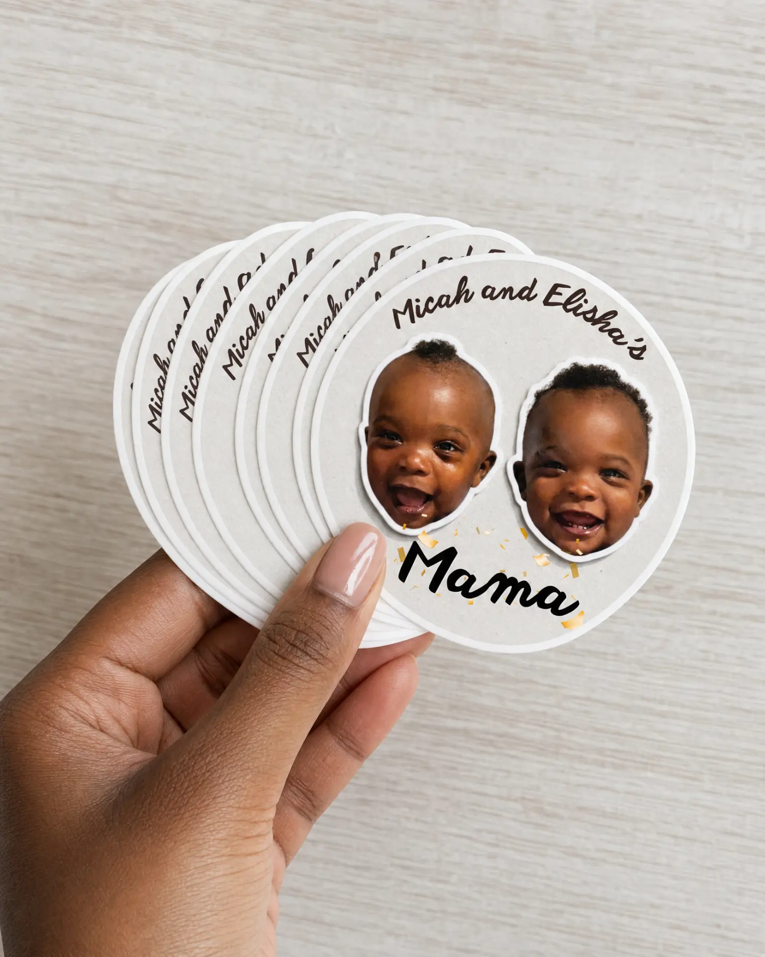 Hand holding a stack of Mama photo stickers